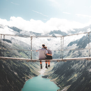 man woman sitting hanging bridge daytime_414077 87 1 1